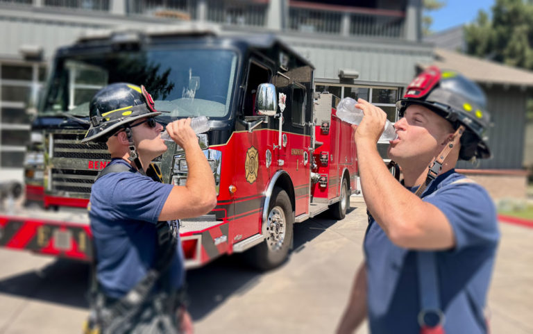 2 fire fighters drinking water