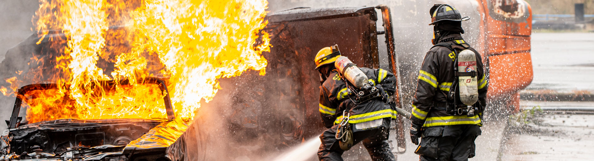 2 Firefighters fighting a car fire