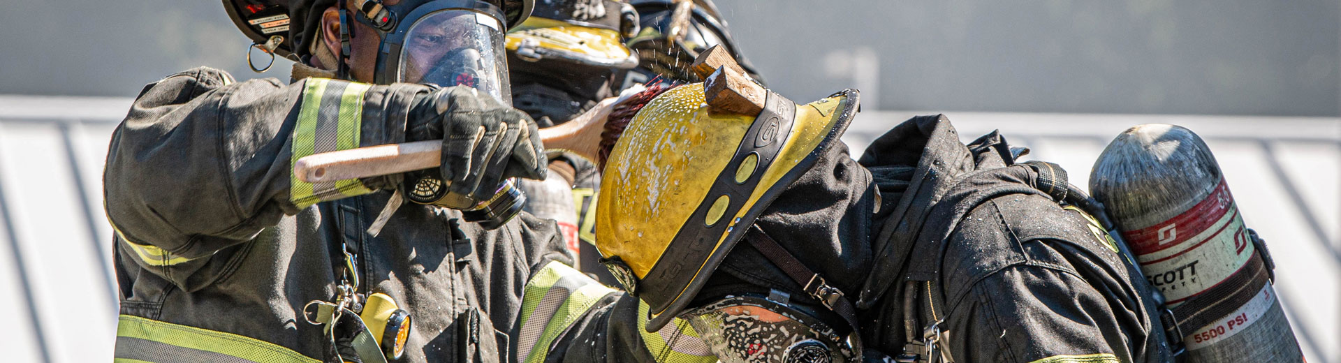 two firefighters doing decon spraying