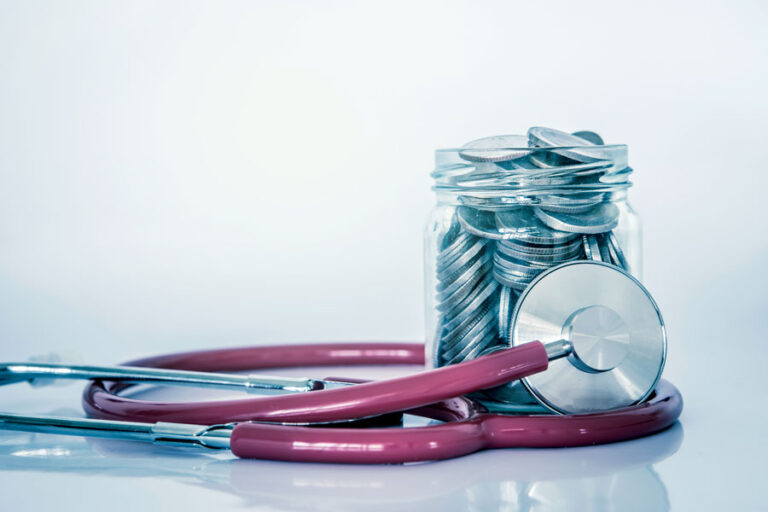 stethoscope and coin jar of savings