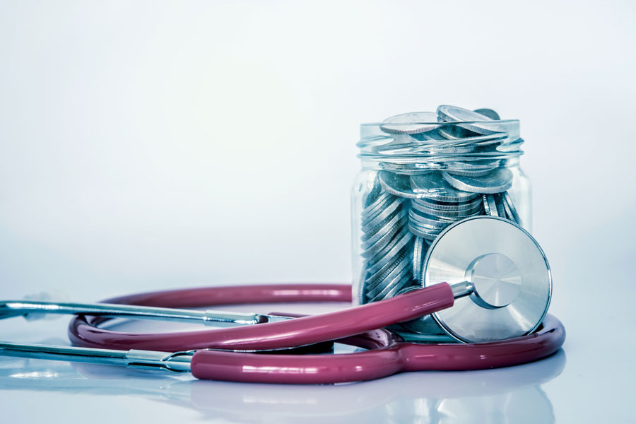 stethoscope and coin jar of savings